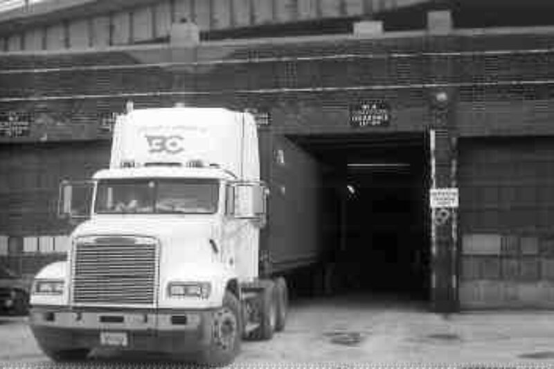LENDING A HAND: A donated tractor and container at the loading dock at the Daily Bread Foodbank's warehouse in Toronto. (Photo by Harry Rudolfs)