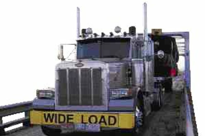 BIG TIME: A Watt & Stewart Pete glides along with yet another load of large Michelin tires.(Photo by Peterbilt)