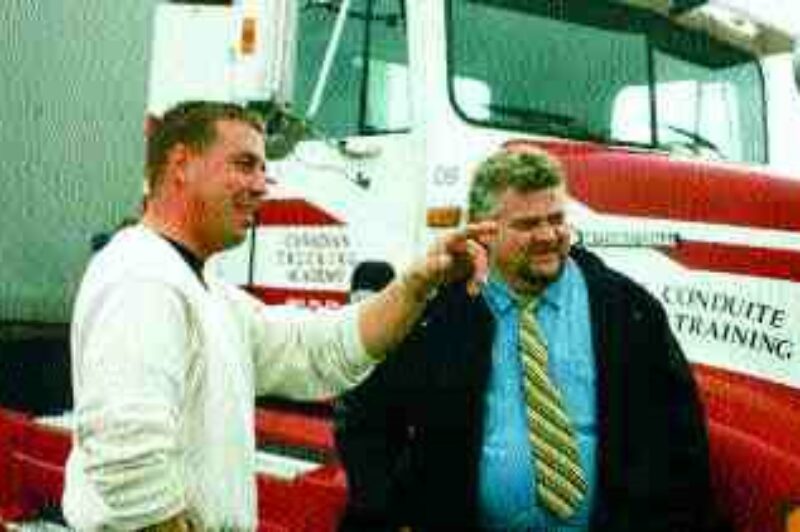 IF I HAD A HAMMER: Cadieux and Traynor watch as the Canadian Trucking Academy's new building takes shape.(Photo by John Curran)