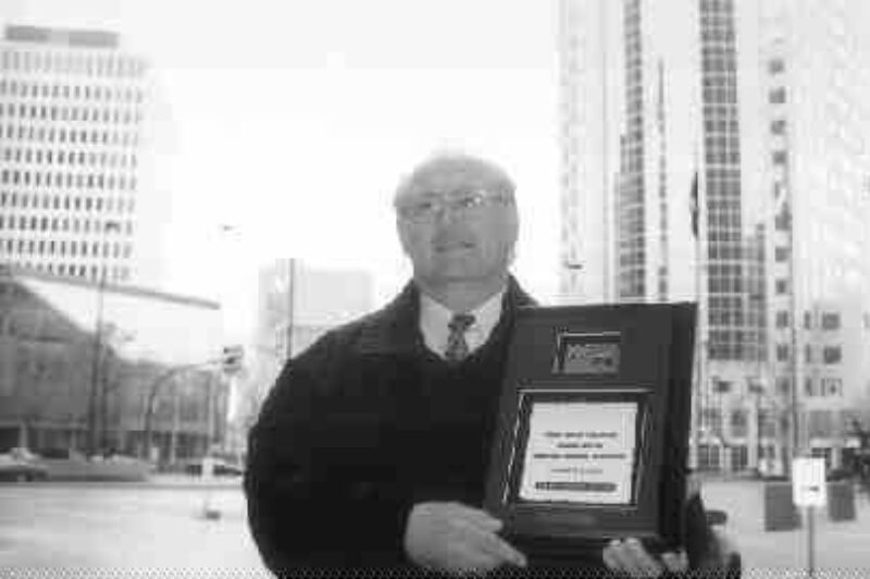 HIS OFFICE: Standing at Portage and Main, this Winnipeg city driver feels right at home. Ozouf explains he has racked up more than two million miles without a preventable accident.(Photo by John Curran)