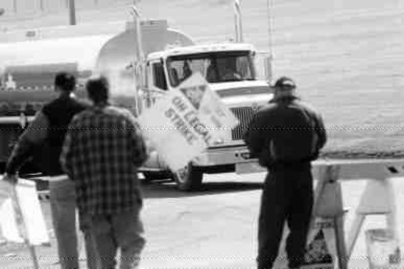 THE TRUCK STOPS HERE: Striking workers hold up a truck entering Petro-Canada's Edmonton refinery. (Photo by James Menzies)