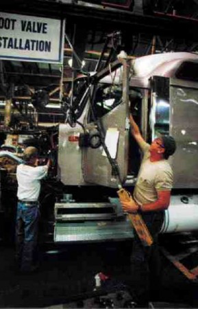 NON-STOP PRODUCTION: As the truck constantly moves on the line, workers hustle around it to create a machine that will travel hundreds of thousands of miles for its pilot.