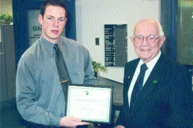 IN PURSUIT OF EXCELLENCE: Bud Barr (right) of the OTA presents the 2002 scholarship to James McCracken (left).
