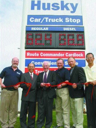 IT'S OFFICIAL: Pictured cutting the ceremonial red ribbon at the grand opening are (l to r):Bill Warner, Husky Energy; Joey Sit, HSBC; Mike Brett, Unipetro; Pierre Simard, Husky Energy; Jim Malvin, Husky Energy and Albert Chou, Unipetro.