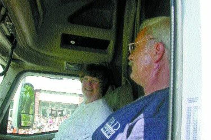 A TEARFUL GOODBYE: Students wave to teacher, Sharon de Vries and driver, Rocky Allen as they pull away from the school. Photo by David Dickenson