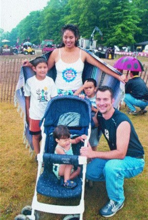 THE GANG'S ALL HERE: Mark Cubitt, a company driver for Transport and Service in Guelph, Ont., with his wife Shannon and their brood: Sequoyah (2), Aaron (7) and Austin (5) braved the rain.Photo by Ingrid Phaneuf