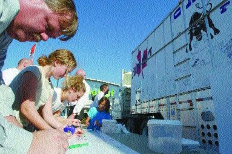SIGN OF SUPPORT: Langley, B.C. residents sign before the liner heads for Ottawa.Photo by Don MacKinnon, Langley Times
