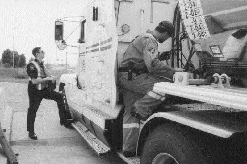 BLITZ: MTO officer Chris Davies speaks to the driver while MTO officer Brent Grice inspects the truck. Photo by Katy de Vries