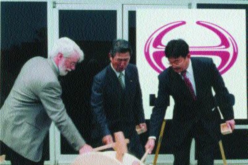 NEW DIGS: Hino officials broke open the sake to celebrate.