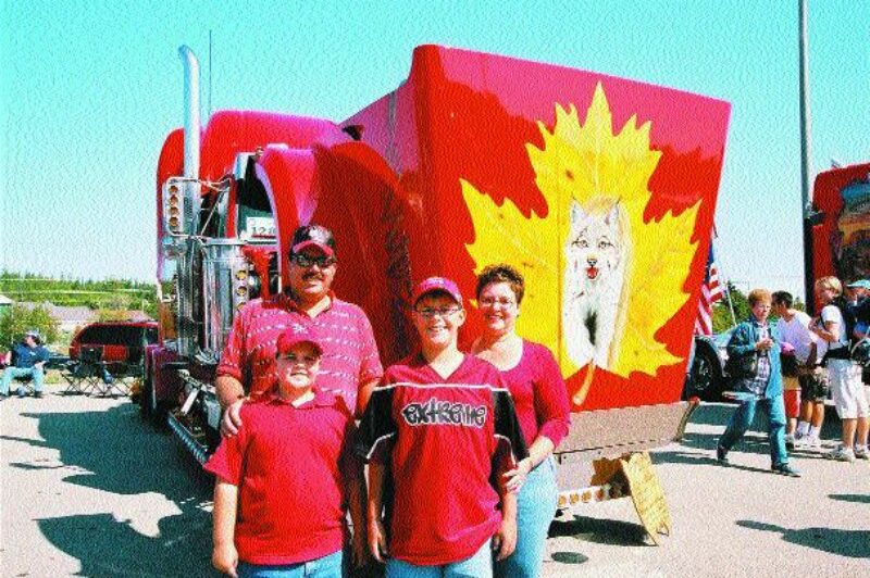 MAPLE LEAF PRIDE: A Canadian was a winner in several categories at the Richard Crane Memorial Truck Show in St. Ignace, Mich. in September. Pierre and Kerry Lee Cinq-Mars, sons Mitchel (youngest) and Matthew from Iron Bridge, Ont. (pictured above) and their truck came in second place (a tie) in Display, Engine, Bobtail Mural, placed third in Bobtail Lights, and came in first in the '02 or newer Bobtail ('02 Western Star) lights category. Congratulations! Photo by Bill Hudgins