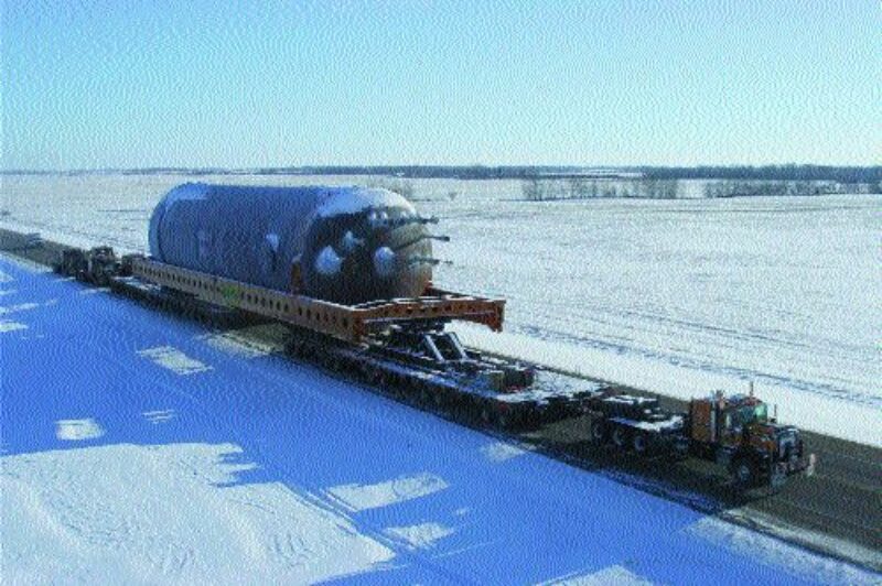 TEAMWORK: Seven trucks were used to haul this load. One to three pulled while up to four trucks pushed the load from behind.