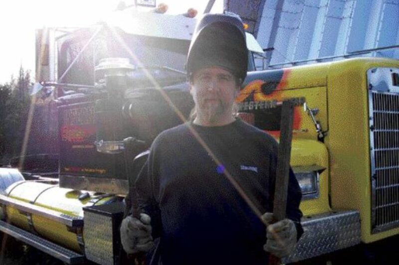 BRIGHT LIGHTS, SMALL CITY: Howard fashions his customized creations at his steel workshop (right background) in the Northern Ontario 