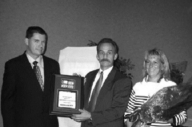 Honoured: William Haslett (centre) was presented with the 