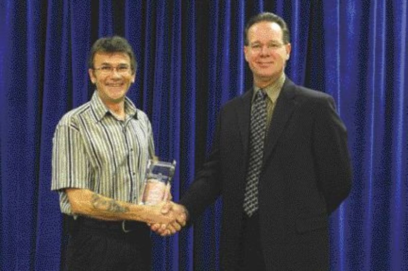 HERO: B.C. truck driver Kevin Harris (left) was recognized as the 2004 Bridgestone/Firestone Canadian Truck Hero after he tried saving the life of a fellow trucker. Tragically, the victim died at the scene, however, Harris provided comfort during his dying moments despite the risk to his own safety.