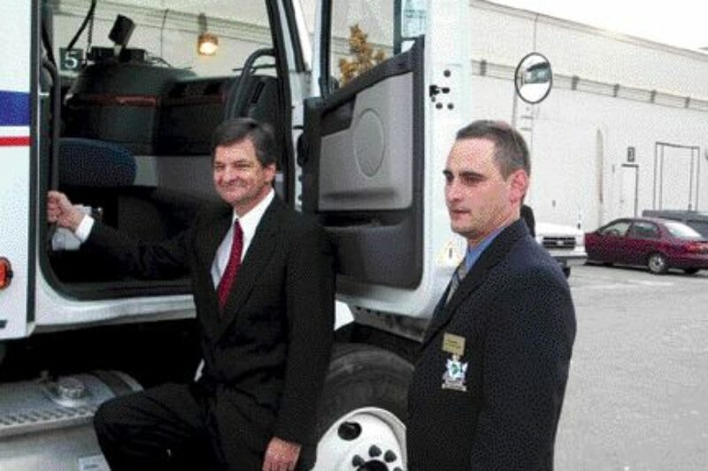NICE RIDE: OTA Road Knight Rob Bedard opens the door for Minister of Training, Colleges and Universities, Chris Bentley. The TST Overland Express driver delivered the Minister to his home riding of London, Ont. following his speech at the OTA's convention.Photo by James Menzies