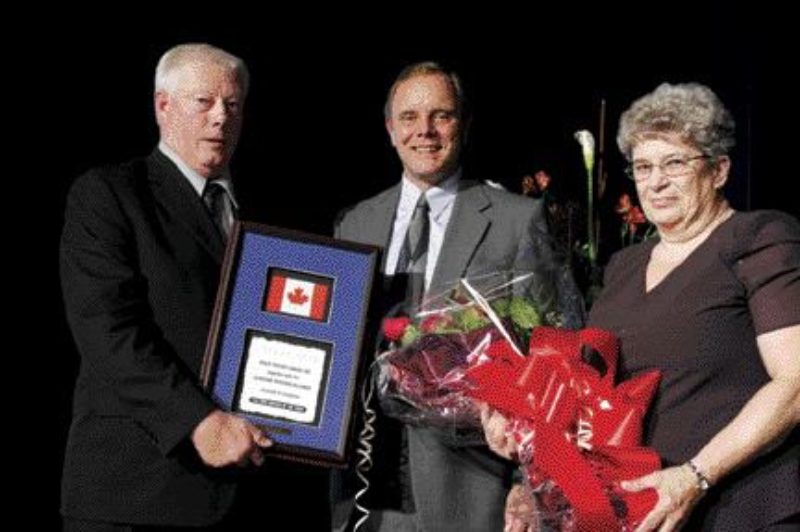 CONGRATS: Wayne Dixon (left) is presented with the CTA/Volvo Trucks Canada Driver of the Year Award. Volvo's Brent Weary presented the award while Dixon's wife Joan looks on.Photo by the OTA