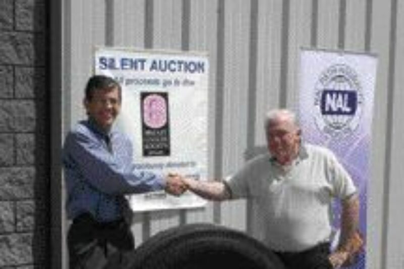 GOOD CAUSE: Stephen Fulton from Fulton Forwarders was the winning bidder on a set of Michelin tires. Terry Fulton (right) accepted the tires on his behalf. He's pictured with NAL president Gary Lindsay (left).