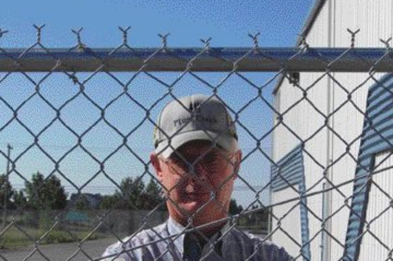 UNIMPRESSED: Ken Bilben looks out from behind the fence of the yard his Kenworth was stolen from. The truck was eventually recovered.