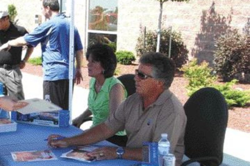 RACING LEGEND: Mario Andretti signs an autograph for a fan at Cambridge Mack. The autograph session was part of a two-day visit.Photo by James menzies