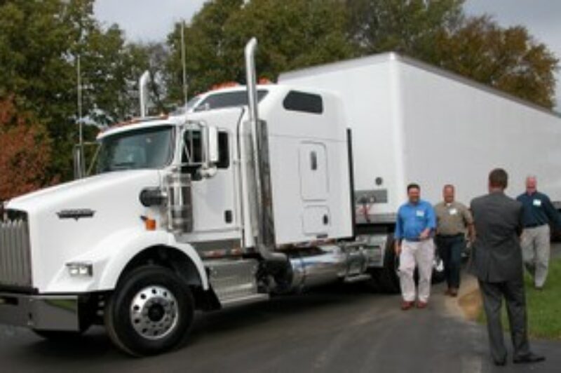 Kenworth customers share a laugh during a test drive at the 