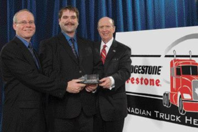 HAPPY HERO: Shawn Berube (centre) accepts the 50th Anniversary Bridgestone Firestone Canadian Truck Hero Award from David Scheklesky, Bridgestone Firestone Canada (left) and David Wilkins, US Ambassador to Canada.