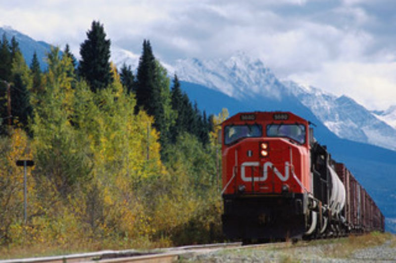 A CN freight train chugs along in a sunny-looking British Columbia, a stark contrast to the province's current harsh winter.