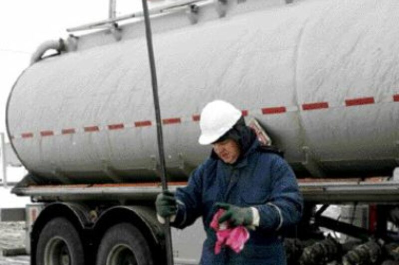 SITUATION CRITICAL: Brad Lawrie checks fuel levels at an Esso station that ran dry during the recent supply shortage.Photo by CP/Nathan Denette