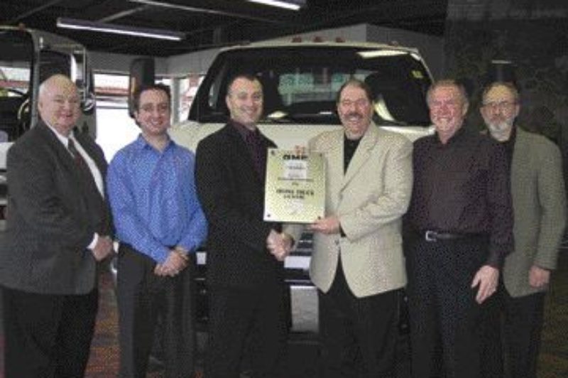 TOP IN SALES: GM staff from left to right are: Frank Gallagher, commcercial truck sales manager, Ontario East; Manny Caruso, Irvine new truck sales manager; Mike Mintsopoulos, Irvine general manager; Joe Aiello, national manager, GM commercial truck sales and field operations; Russ White, Irvine truck sales representative; and Bob Reid, assistant manager, GM national commercial truck sales. Photo by Adam Ledlow