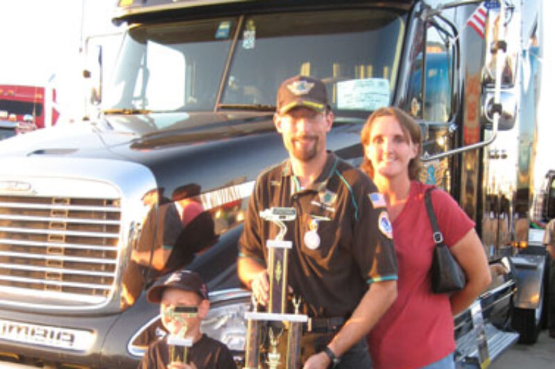 Matthew Slovak stands with his son, Nathan, and his wife, Candice, after winning the second annual Gary King Trucker Buddy trophy.