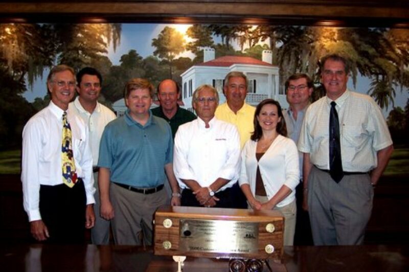 PSI and Great Dane staff pose with the award.