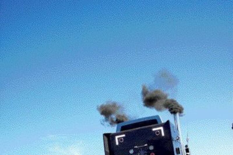 UP IN SMOKE: A racing competitor heaves forward during a time trial at the Earl Hardy Big Rig Nationals in Grand Bend, Ont. Photo by Adam Ledlow