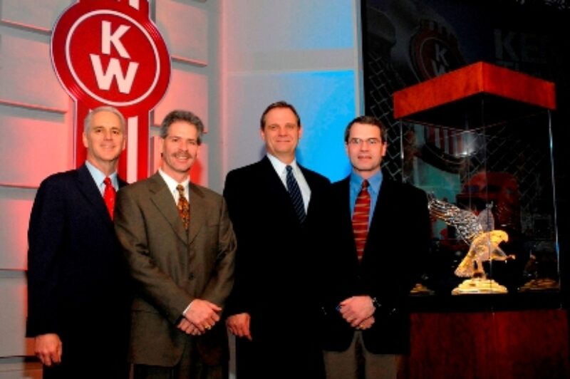 From left are Gary Moore, Kenworth assistant general manager for marketing and sales; Ken Leach, Custom Truck Sales; Bob Christensen, Kenworth general manager; and Brent Leach, Custom Truck Sales.