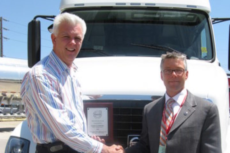 Dan Cushing (left), director of maintenance for Ryder Transportation, receives congratulations from award sponsor, Don Coldwell of Volvo Trucks Canada. In addition to the plaque shown, Cushing will also receive a ring, a paid vacation, and have his name added to the winners' trophy.