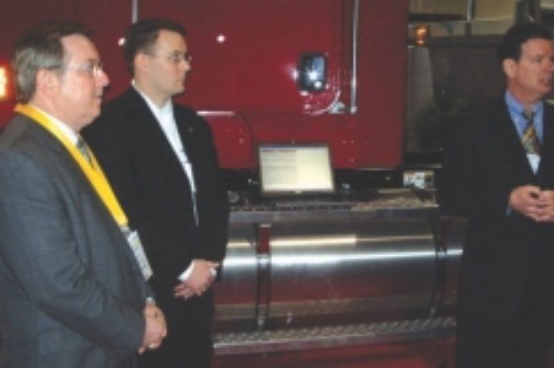 HOW IT'S DONE: Transport Minister Jim Bradley (left), Cummins rep Adam Whitney (middle) and OTA chief David Bradley, set a speed limiter at Truck World.