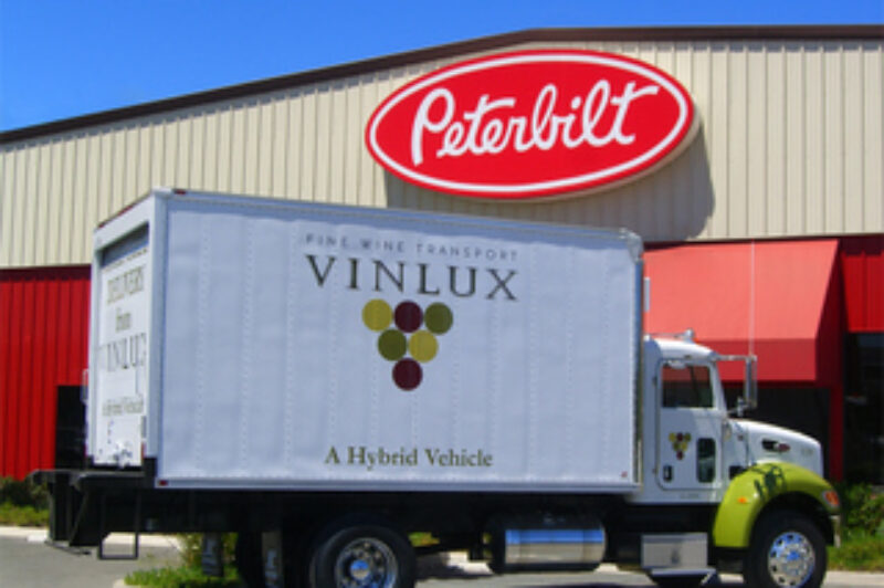 Peterbilt has delivered its first two production hybrids to a wine delivery company in Napa Valley.