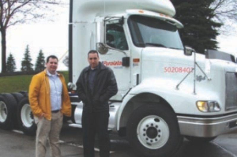 READY TO ROLL: The author, James Menzies (left) and Roadranger's Mike Sharpe get ready to take Purolator's newest truck for a spin along the 401 and Derry Rd. in Mississauga.