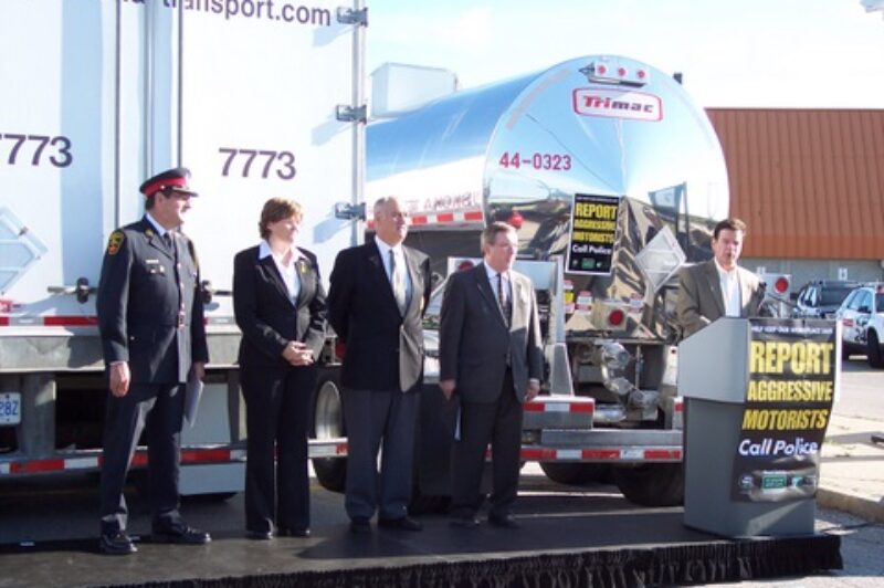Ontario Trucking Association president David Bradley speaks this morning at the launch of a joint campaign to catch aggressive drivers on the highway. Pictured left to right: Deputy Chief Chuck Mercier, OPP Commissioner Julian Fantino, Debbie Virgoe, and Transport Minister Jim Bradley.