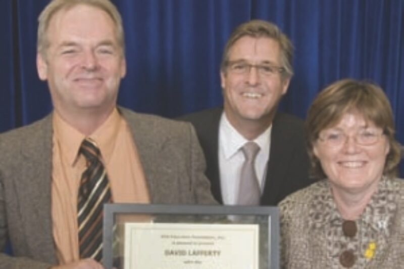 INAUGURAL AWARD: David Lafferty Sr. (left) accepts the award on behalf of his son, David Jr., from Debbie Virgoe (right) and Scott Smith, chairman of the OTA's Education Foundation (middle).