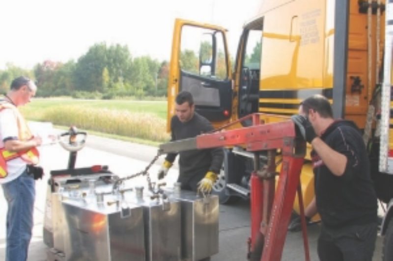 ACCURACY COUNTS: Researchers from FPInnovations weigh the fuel tanks to get an accurate reading on fuel consumption during Energotest 2007.