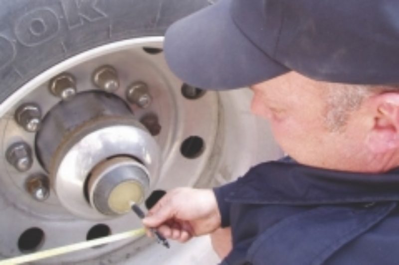 A MATTER OF INCHES: MTO officer Bill Vangou demonstrates how inspection officers measure wheelbase length.