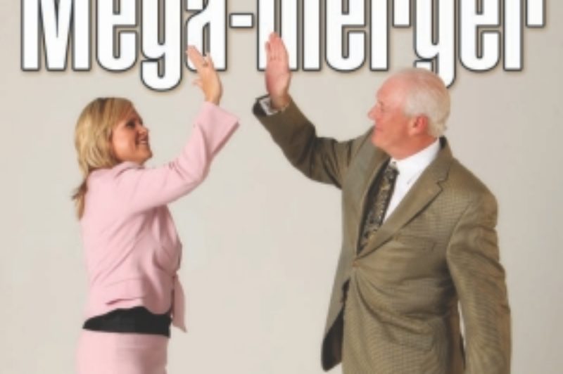 HIGH FIVES ALL AROUND: Industry analysts applauded the summer's major trucking acquisition, with MacKinnon Transport acquiring Walker Group. Pictured, Julie Tanguay of Walker Group and Evan MacKinnon of MacKinnon Transport celebrate the new deal which creates the newest Canadian truckload powerhouse.