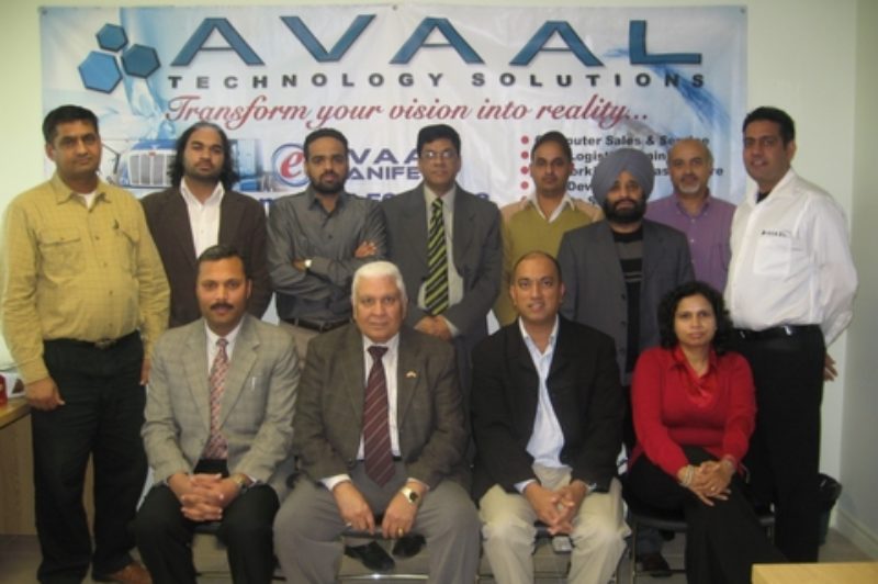 Avaal's latest group of grads poses with special guests after the ceremony in Brampton Dec. 6.