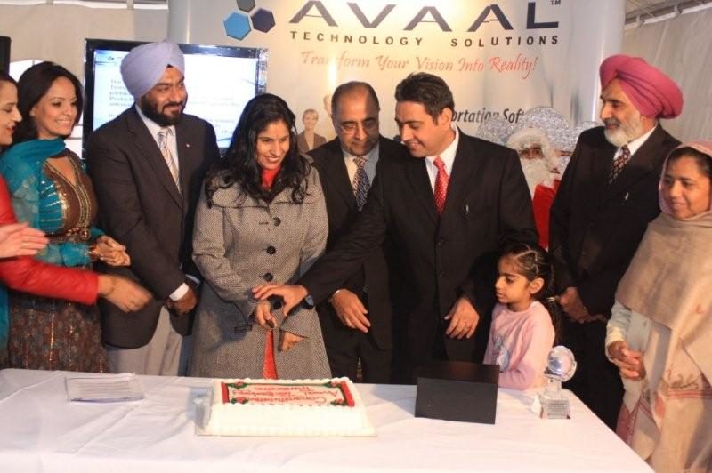 Dara Nagra (fourth from right), president and CEO of Avaal Technology Solutions, cuts the cake during the company's customer appreciation day Dec. 12. Local dignitaries, customers and even Santa Claus made an appearance at the well-attended event.