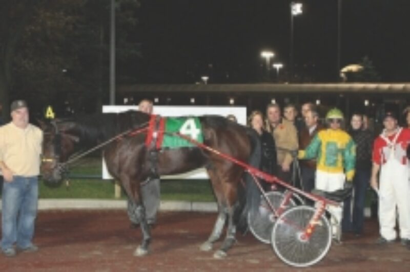 SPECIAL RECOGNITION: Kevin Burch (far left) was able to present a trophy to the owner of Caviar's Dream, winner of the first ever Truckload Carriers Association Race at Woodbine.