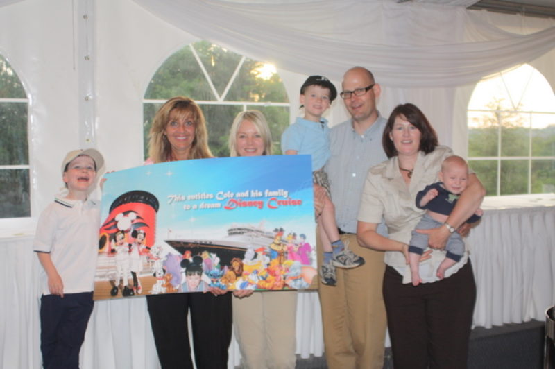 Truck News associate publisher Kathy Penner (second from left) and tournament founder Brenda Grant (third from left) pose with five-year-old Cole (left) and his family after receiving a ticket for a dream Disney cruise at last year's Truck News/Chevron golf tournment.