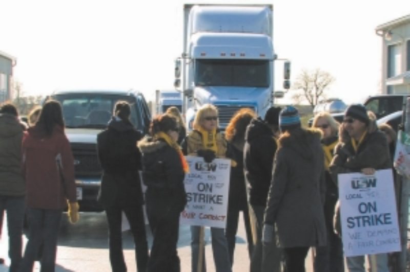 SLOW ROLL: DriveTest management began providing road tests for some commercial drivers in November. Here, striking DriveTest workers picket as managers provide road tests at KRTS Transportation Specialists Nov. 18.