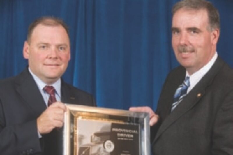 CONGRATS: Jim Coles (right) was named Ontario's Driver of the Year. The MacKinnon driver is seen here accepting his award from Volvo Trucks Canada's Peter Currie.