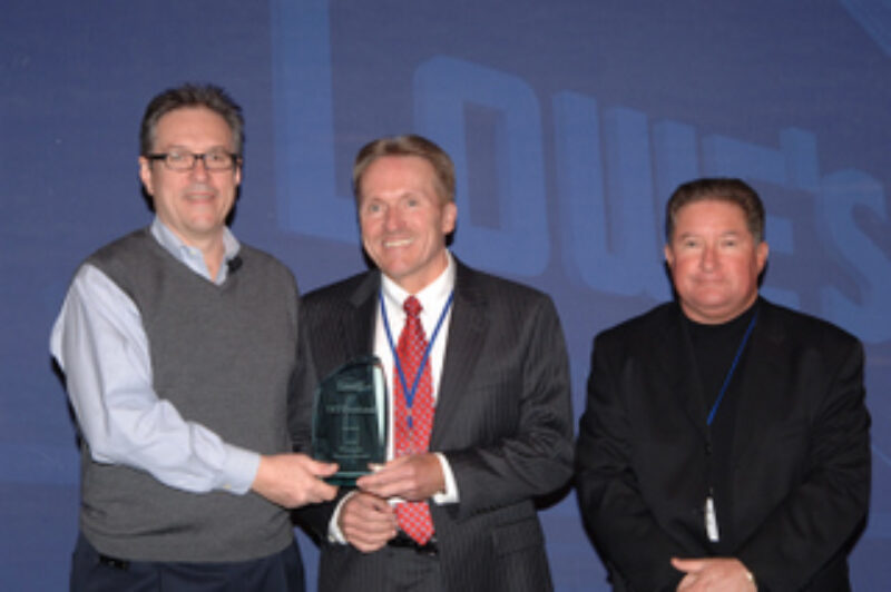 Steve Palmer, vice-president, transportation, Lowe's Companies presents the Platinum Service Award to Rob O'Reilly, president, TST Overland Express (centre) and Reg Peters, vice-president, corporate accounts, TST Overland Express (right).