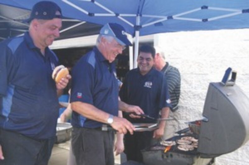 THANK YOU BBQ: Quick Truck Lube staff kept their burgers hot and their heads dry during the company's customer appreciation day July 9.
