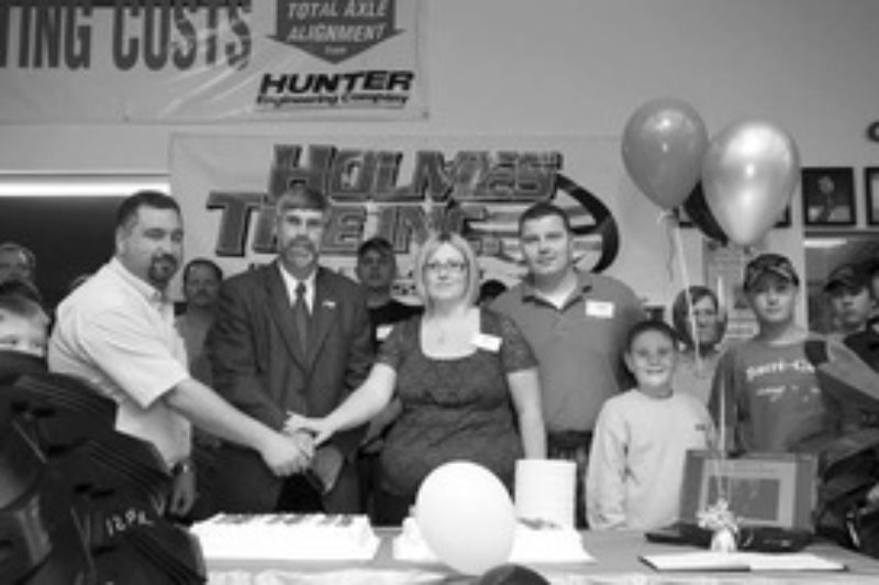A NEW HOME: Holmes Tire held the grand opening ceremony for its new Orangeville facility June 12. Pictured from left to right are Mike Holmes, Deputy Mayor Warren Maycock, Terry Holmes and Jim Prince.